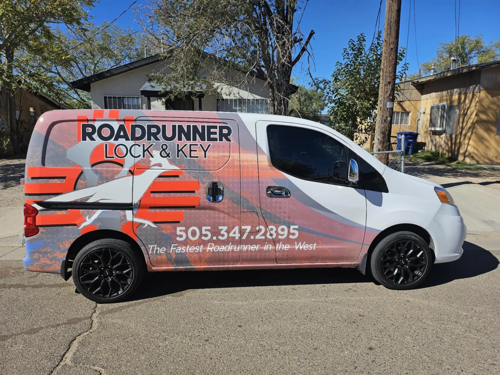 Side of the Roadrunner Lock and Key van showing the company name and phone number 505.347.2895